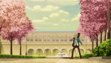 a man walking in front of a building with cherry blossom trees in the background