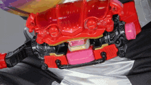a close up of a red and pink toy with the letters td on the bottom