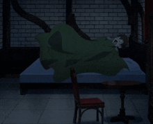 a man in a green cape is laying on a bed in a dark room