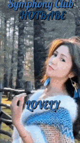 a woman in a blue and white sweater with the words symphony club hotbabe lovely