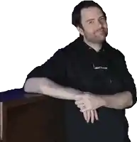a man wearing a black sweatshirt with the word machine on the front