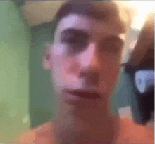a blurry picture of a man 's face with a purple eye
