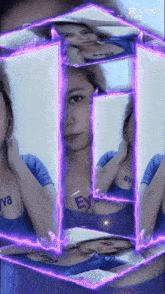 a woman in a blue shirt with the word ey on her chest is surrounded by purple lights