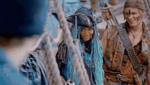a man and a woman are standing next to each other on a boat .