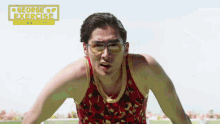 a man wearing sunglasses and a red tank top with the words george 's exercise written on it