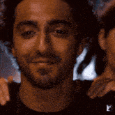 a man with a beard wears a black shirt with the letter z on the sleeve