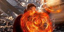 doctor strange is holding a shield with a circle of fire around him in a scene from avengers : infinity war .