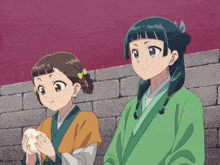 two anime girls are standing next to each other and one is holding something in her hands