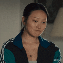 a woman is wearing a netflix jacket and a necklace