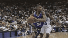 a basketball player wearing number 34 is dribbling the ball