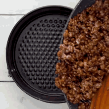 a pan of food is being poured into a pan that says easy plus on the bottom