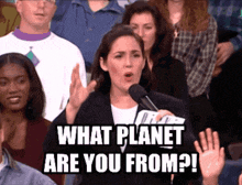 a woman speaking into a microphone with the words " what planet are you from "