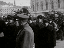 a black and white photo of a group of people walking