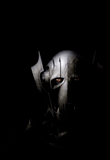 a close up of a robot head with a black background