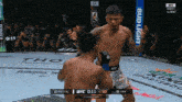 two fighters in a boxing ring with a bud light banner behind them