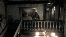 a black and white photo of a staircase with a painting on the wall behind it