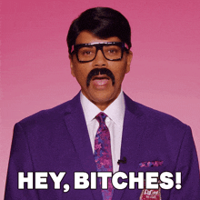 a man with glasses and a mustache is saying hey bitches