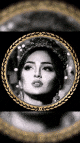 a black and white photo of a woman wearing a tiara