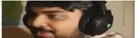 a man with a beard is wearing headphones .