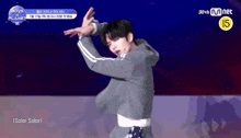 a man is dancing in front of a sign that says boys on planet k