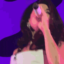 a woman is singing into a microphone while wearing a hat