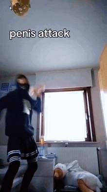 a person dancing in front of a window with penis attack written on the bottom
