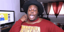 a man wearing a black hat and a red shirt that says ' chicago ' on it