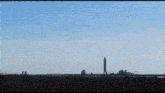 a rocket is being launched into the sky with a large explosion in the foreground