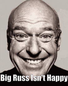 a black and white photo of a smiling bald man with the words big russ isn 't happy below him