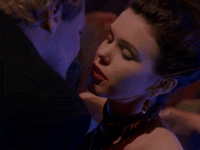 a man and a woman are kissing in the dark