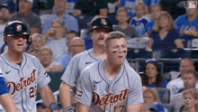 a group of detroit baseball players are standing on the field .