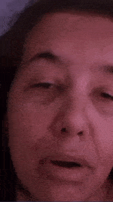a close up of a woman 's face with her mouth open .
