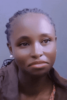 a close up of a woman 's face with a sad expression