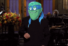 a cartoon character with a green head and a blue ribbon around his neck