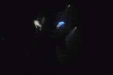 a person in a dark room with a light shining on them