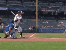 a baseball game is being played in a stadium with a lecom sign in the outfield