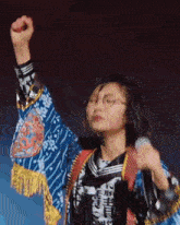 a woman in a kimono holds up her fist in the air while wearing a shirt that says hi gamao