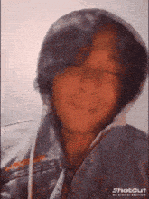 a close up of a person wearing a hoodie with the word shotcut on the bottom