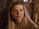 a woman with long blonde hair and a choker necklace