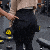 a woman is holding a dumbbell that says beko 12