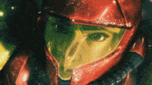 a close up of a person wearing a red helmet with a yellow lens