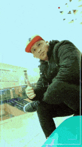 a man wearing a red and yellow hat is kneeling down