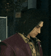 a man with long hair is wearing a maroon jacket and a leopard print shirt