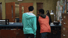 a man in a green hoodie is standing next to another man