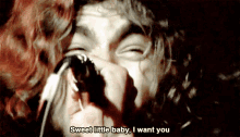 a man singing into a microphone with the words sweet little baby i want you