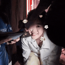 a person is putting stickers on a young girl 's face .