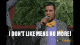 a man singing into a microphone with the words " i do n't like mens no more " behind him
