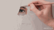 a person is painting a woman 's face with a brush and the words made in animatica on the bottom