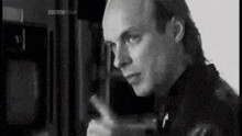 a black and white photo of a man with the bbc logo on the bottom right