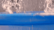 water is pouring into a blue container with the number 12 visible